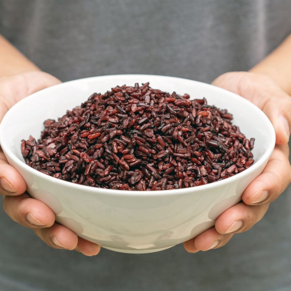 men holding a riceberry in a white bowl