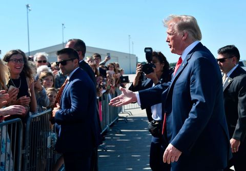 us president trump walks to greet supporters after landing at sioux falls regional airport to attend a fundraiser in sioux falls, south dakota on september 7, 2018 photo by nicholas kamm  afp        photo credit should read nicholas