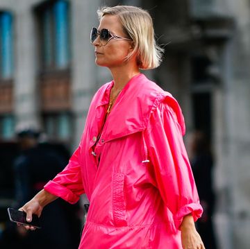 a guest wears sunglasses, a pink dress, black sandals, during london fashion week september 2018 on september 14, 2018 in london, england photo by edward berthelotgetty images