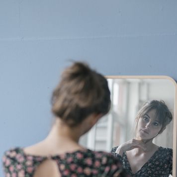midlife crisis signs obsession over appearances woman looking in mirror