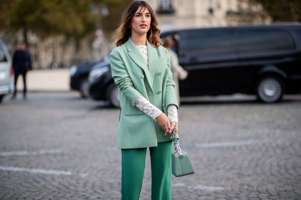 Jeanne Damas wearing green blazer, flared pants is seen outside Valentino during Paris Fashion Week Womenswear Spring/Summer 2019 on September 30, 2018 in Paris