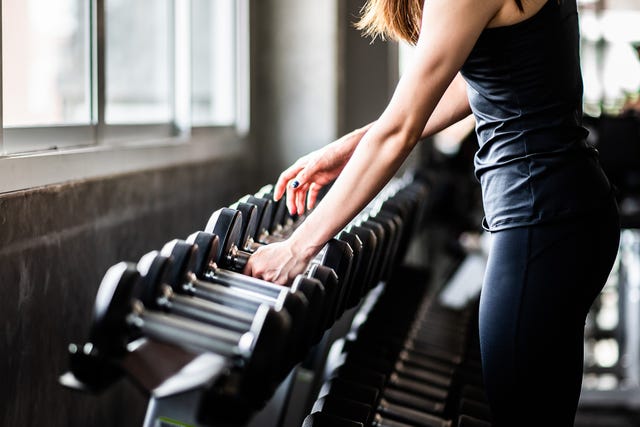 young woman exercising in gym