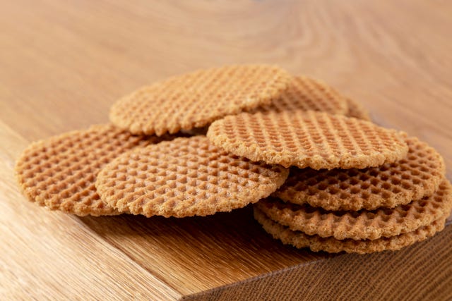 Waffles scattered on a wooden table. Macro. Copy space.