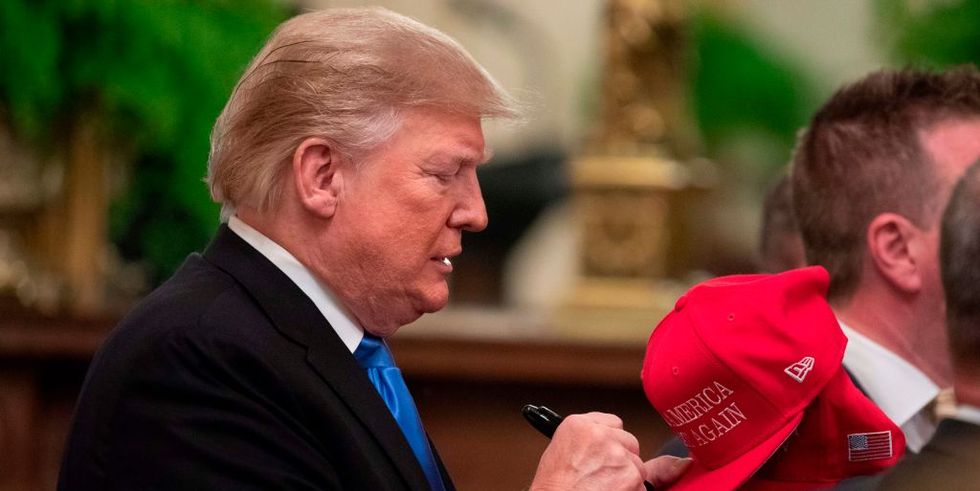 us president donald trump signs hats after addressing the young black leadership summit at the white house on october 26, 2018 in washington, dc photo by alex edelman  afp        photo credit should read alex edelmanafp via getty images