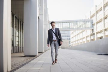 a man walking on a stone walkway