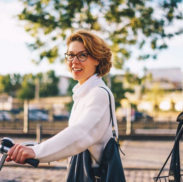 portrait of a beautiful woman with a bicycle in berlin, germany