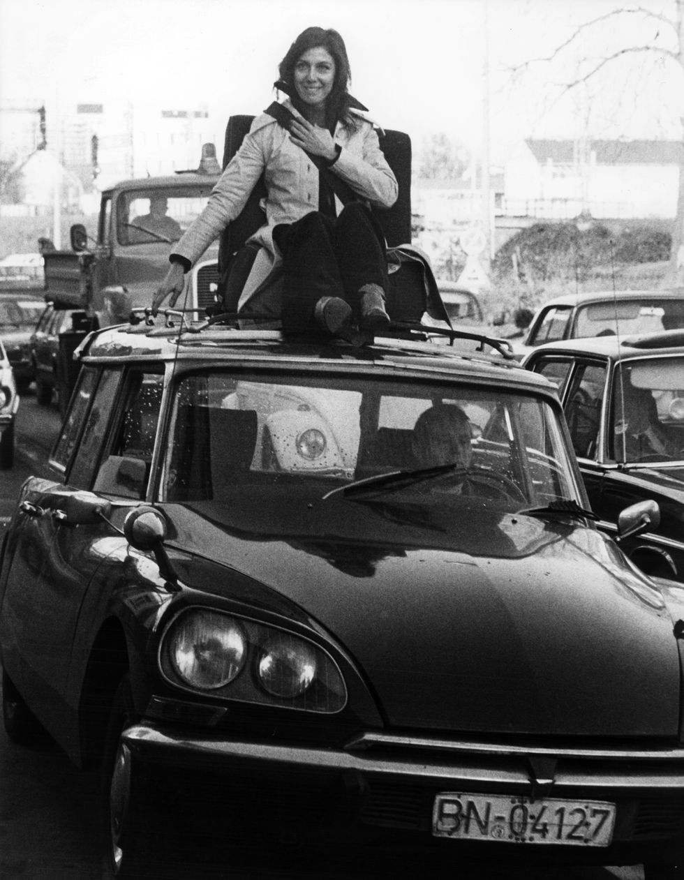 a woman drives being strapped up on a seat positioned on the roof of a car in bonn on 7 december 1976 with this unusual campaign the council for road safety and the german ministry of transport wanted to fight against the falling rate of people strapping up themselves in cars usage worldwide photo by peter popppicture alliance via getty images