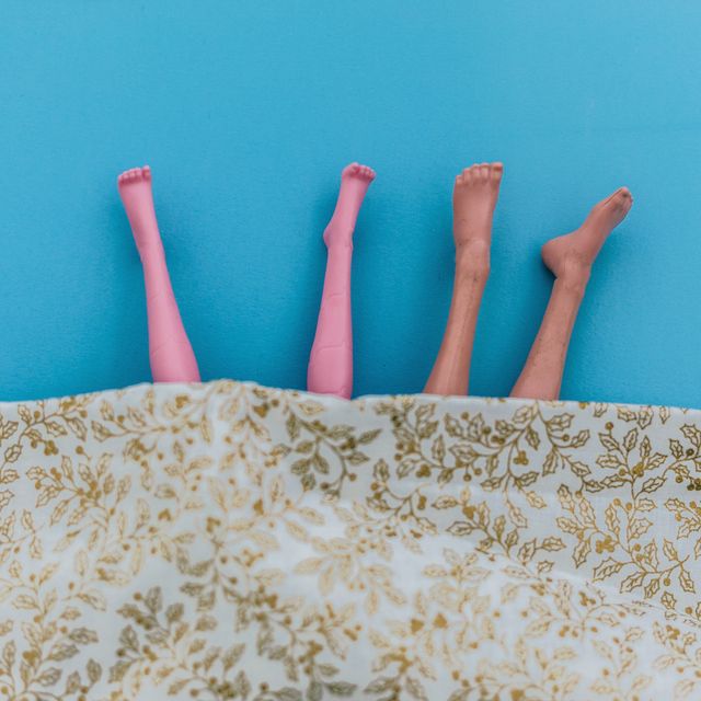 female and male doll  legs in bed
