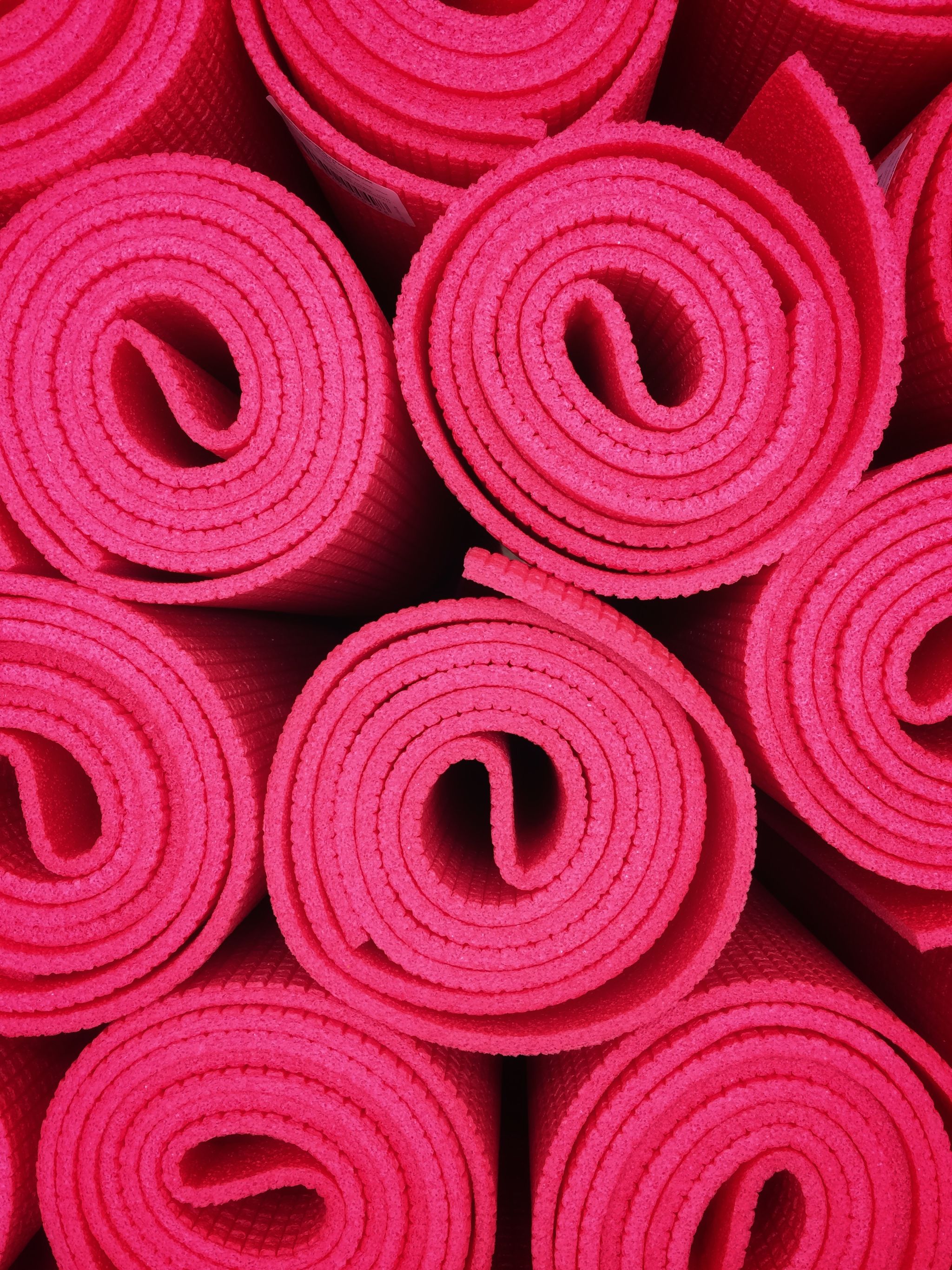 Pink yoga mat rolls.