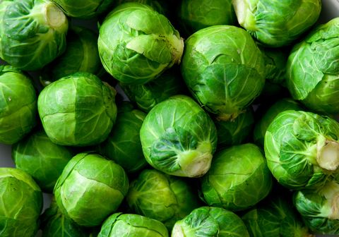 a dish full of uncooked, unpeeled brussels sprouts natural, soft lighting