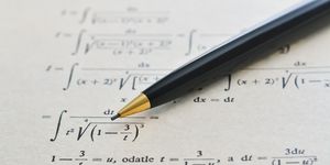 pencil over a math book and advanced example with integrals