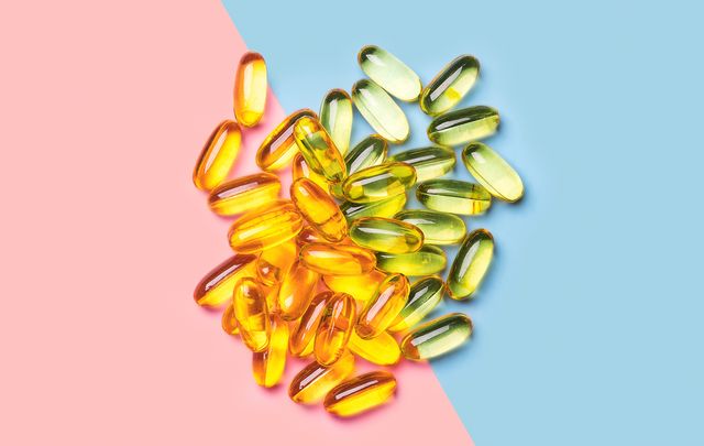 Fish oil capsules from above on pink and blue