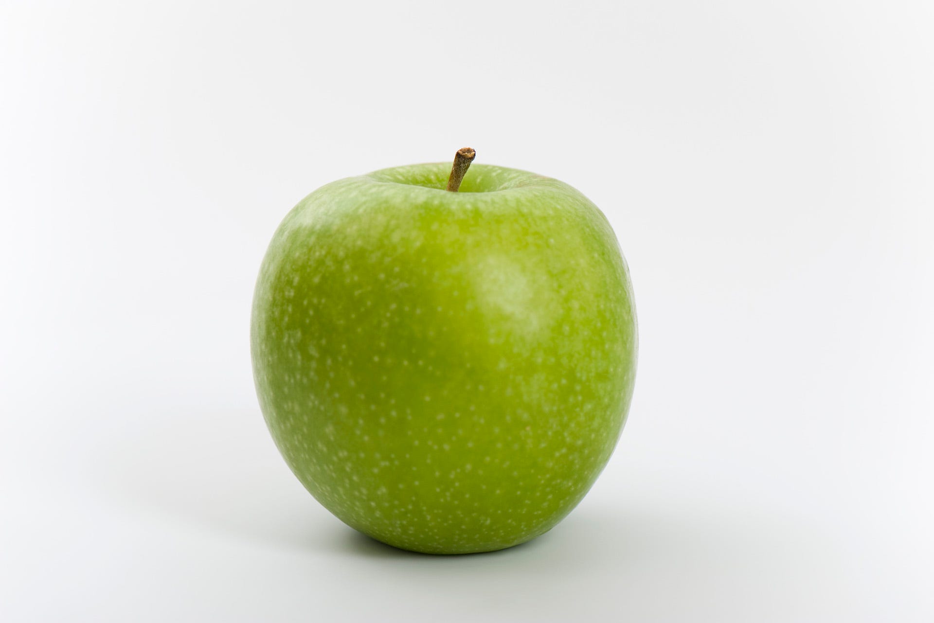 a green apple with a stem