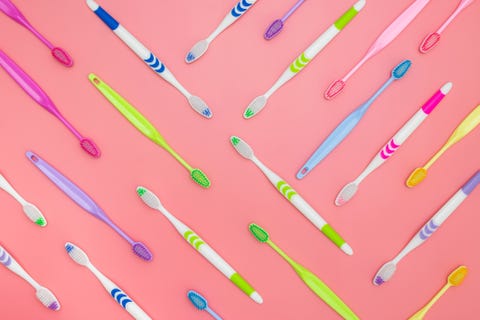 Top view of toothbrushes in colorful on pastel color background.