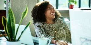 Candid portrait of mixed race professional woman laughing