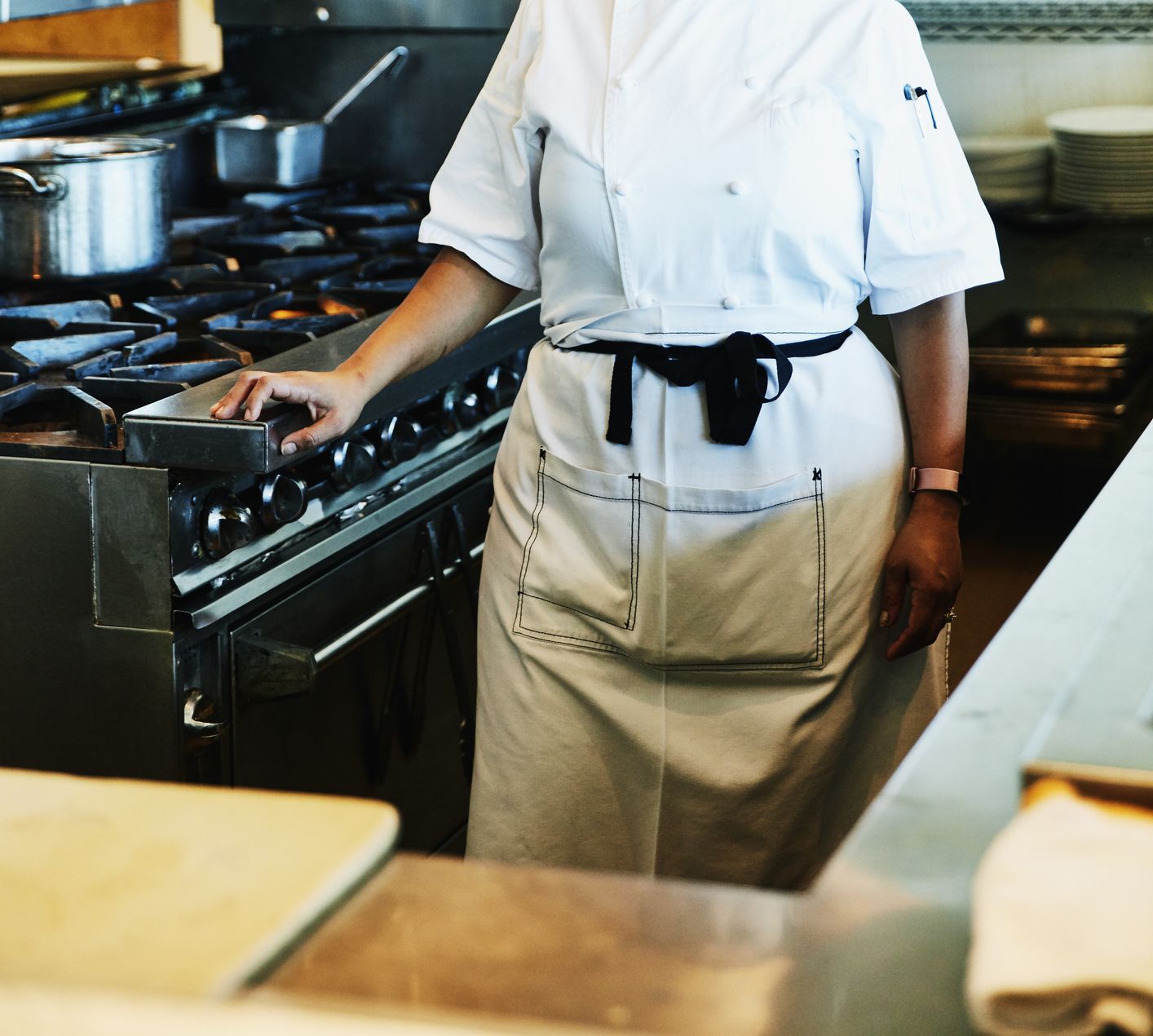 Portrait of smiling female chef in restaurant kitchen