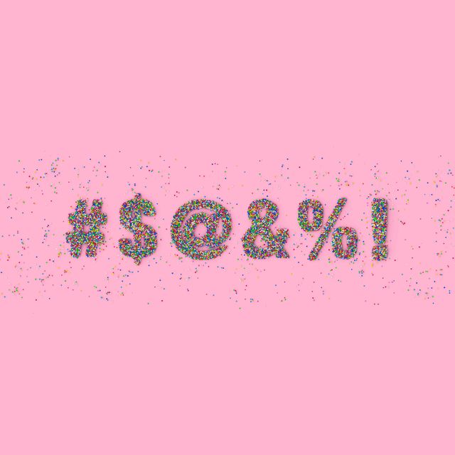 $ symbols made out of colorful candy sprinkles representing swearwords on pink background