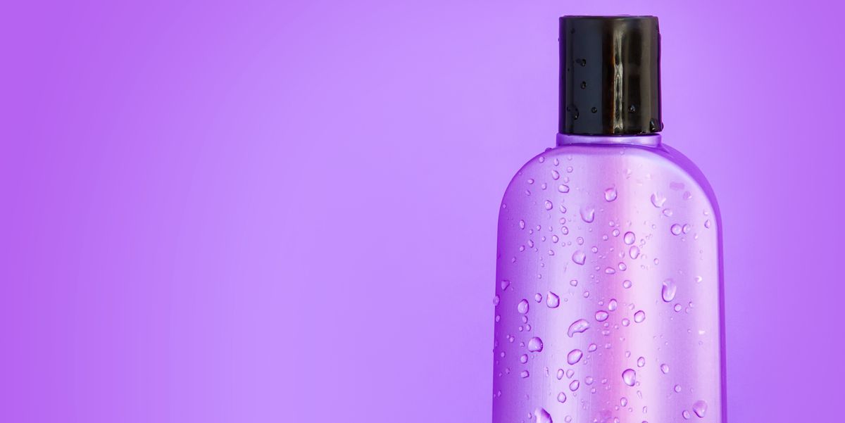 macro cosmetic purple wet bottle on a purple background. Horizontal,copy space