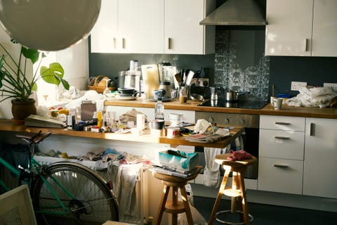 Messy apartment counter tops covered in clutter