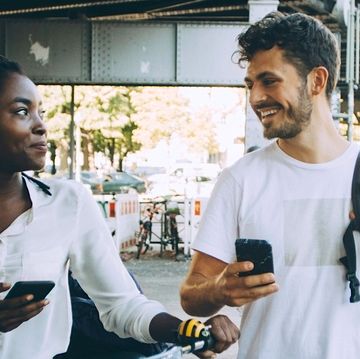a man and a woman looking at a phone