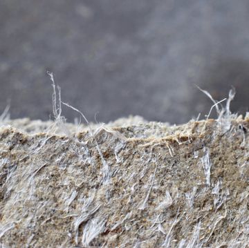 detailed photography of roof covering material with asbestos fibres health harmful and hazards effects prolonged inhalation of microscopical fibers causes fatal illnesses including lung cancer