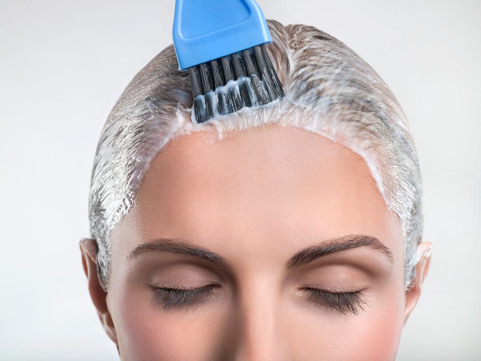 young woman applying hair color