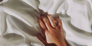 Cropped Hand Of Woman On Sheet