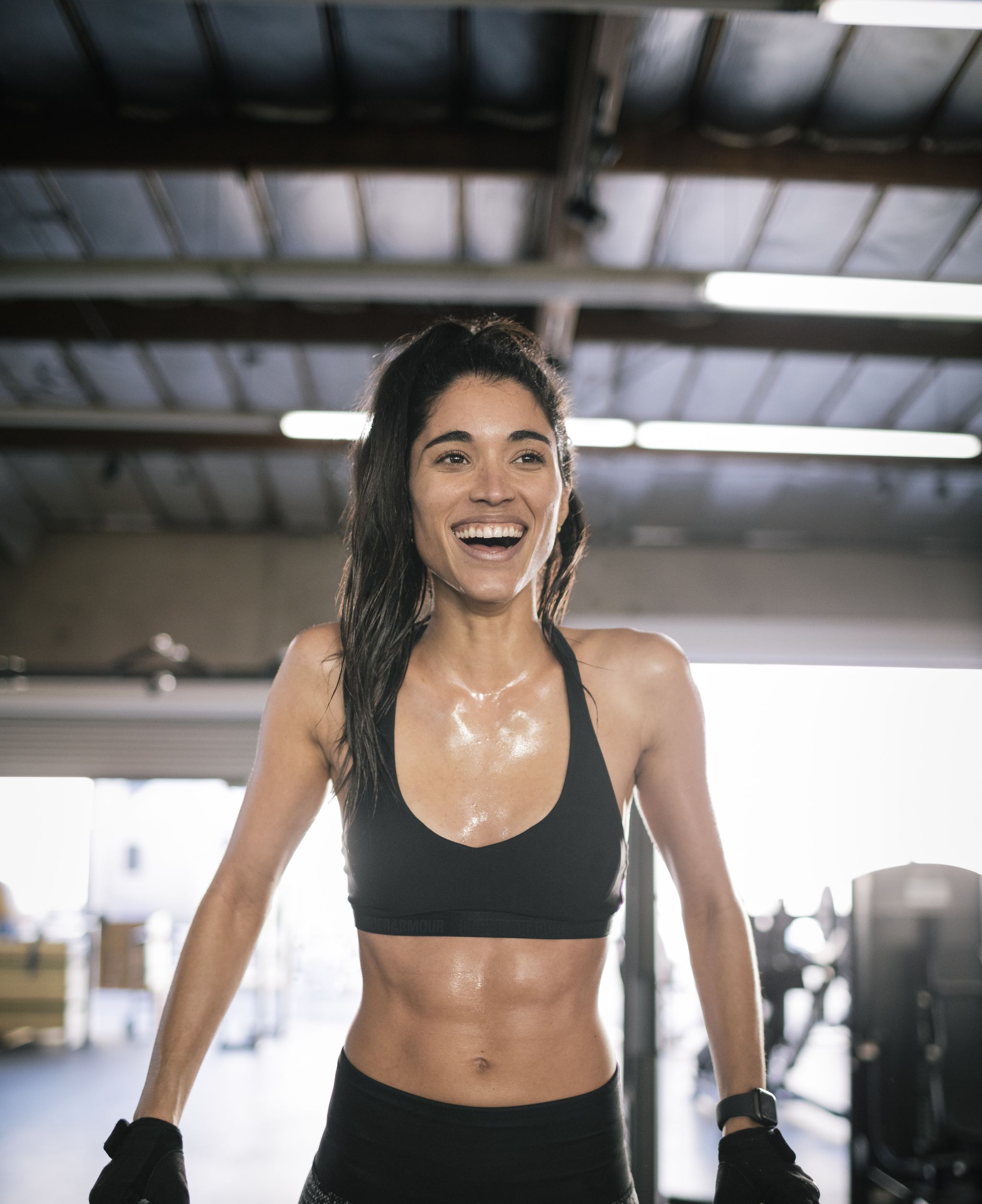 young female athlete smiling   abs workout