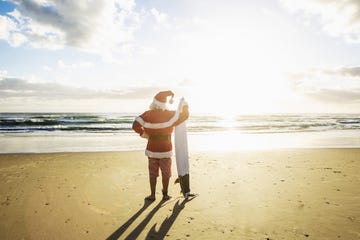 santa relaxing with a visit to the beach after the busy days of christmas