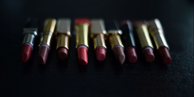 Nine lipsticks on a black background
