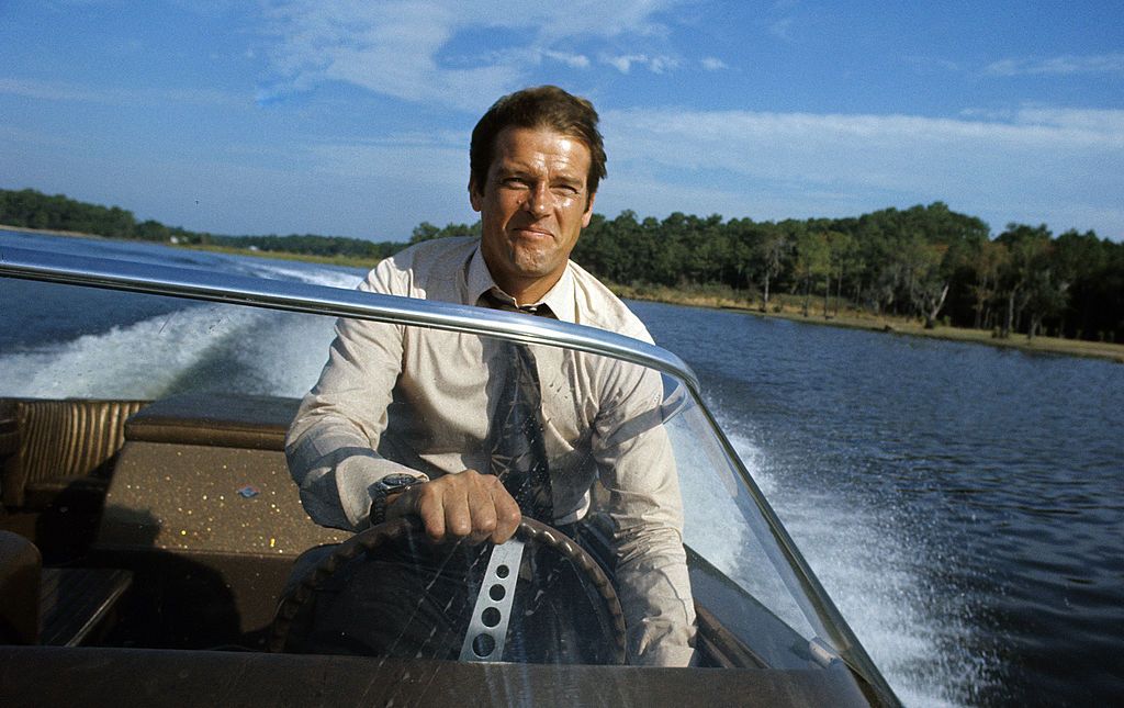 kingston, jamaica march 1 roger moore poses driving a speedboat during the filming of james bond film live and let die on march 1, 1973 in kingston, jamaica photo by anwar husseingetty images