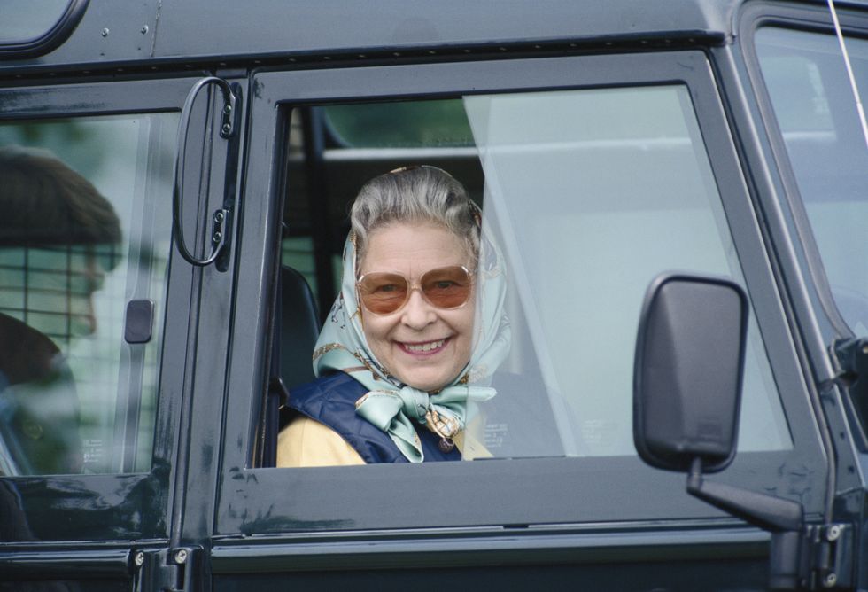 queen elizabeth ii, wearing a headscarf, smiling as she looks through the window of her car at the royal windsor horse show, in the grounds of windsor castle, windsor, berkshire, england, great britain, circa 2000 photo by tim graham photo library via getty images