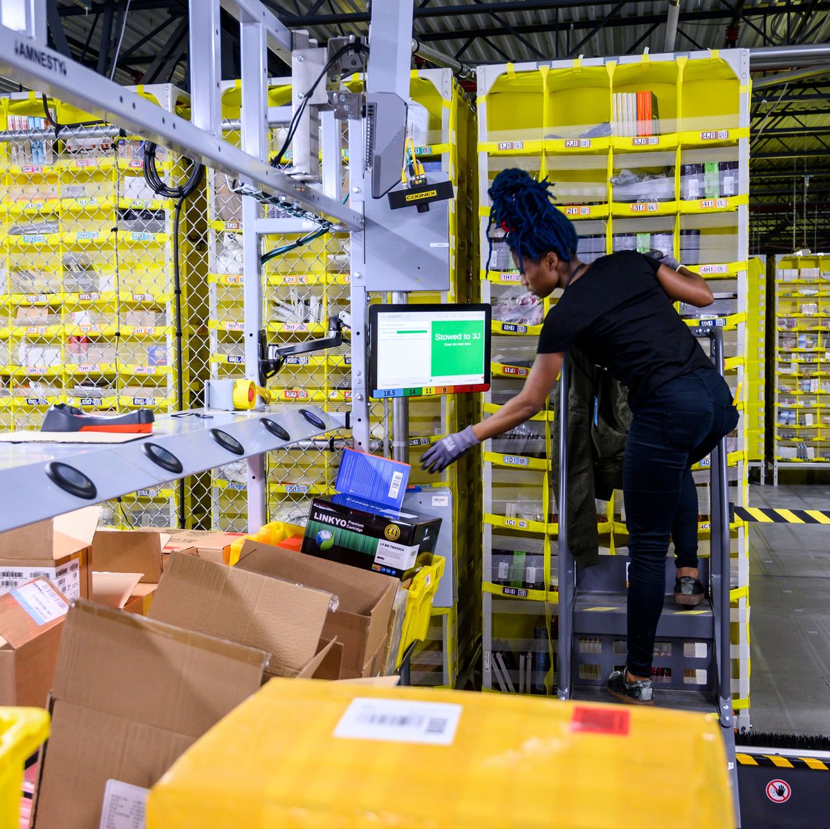 a woman works at a distrubiton station at the 855,000 square foot amazon fulfillment center in staten island, one of the five boroughs of new york city, on february 5, 2019   inside a huge warehouse on staten island thousands of robots are busy distributing thousands of items sold by the giant of online sales, amazon photo by johannes eisele  afp        photo credit should read johannes eiseleafp via getty images