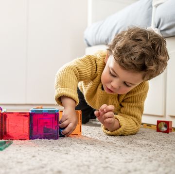 young boy playing with building blocks