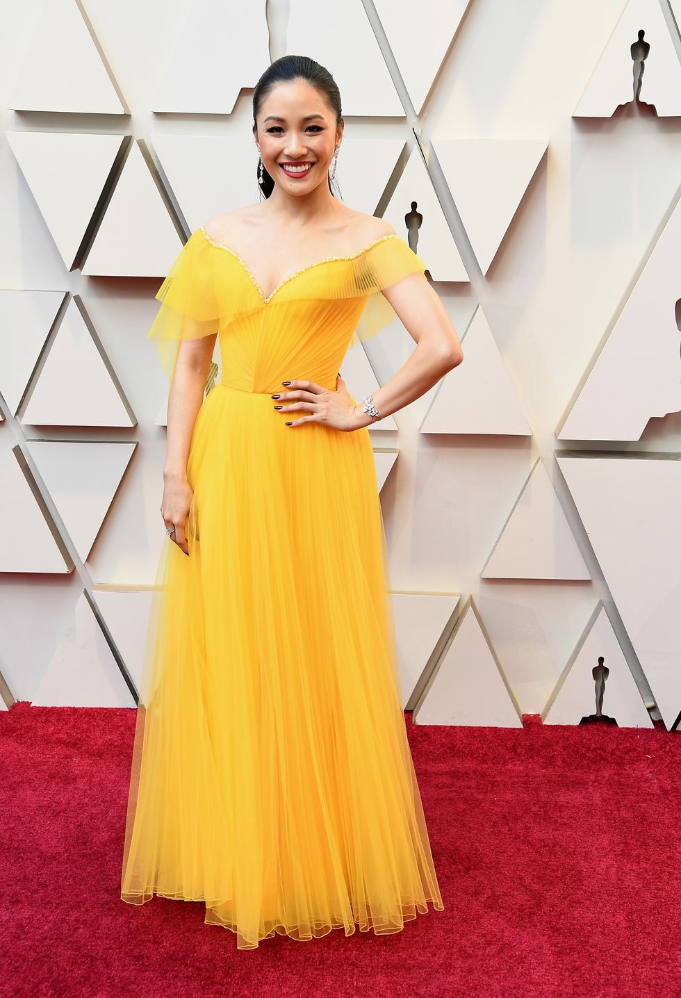 Dress, Clothing, Gown, Yellow, Shoulder, Red carpet, Fashion model, Carpet, A-line, Flooring, 
