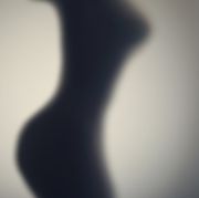 silhouette of naked womans body  behind glass door concept