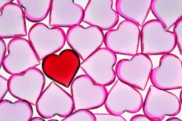 glass hearts on white background, overhead view