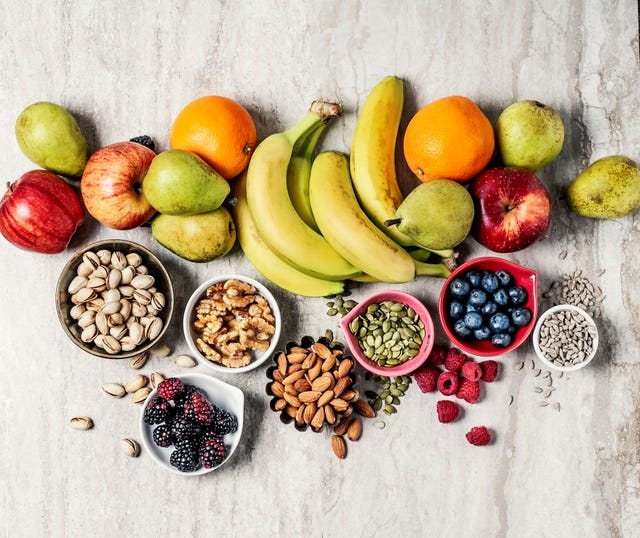 variety of fruits and nuts on gray background