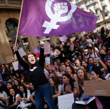 a woman waves a feminist flag as student protesters shout slogans during a demonstration marking international womens day in barcelona on march 8, 2019 unions, feminist associations and left wing parties have called for a work stoppage for two hours on march 8, hoping to recreate the strike and mass protests seen nationwide to mark the same day in 2018 photo by pau barrena afp photo by pau barrenaafp via getty images