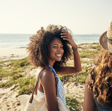 shot of two young women spending time together at the beach