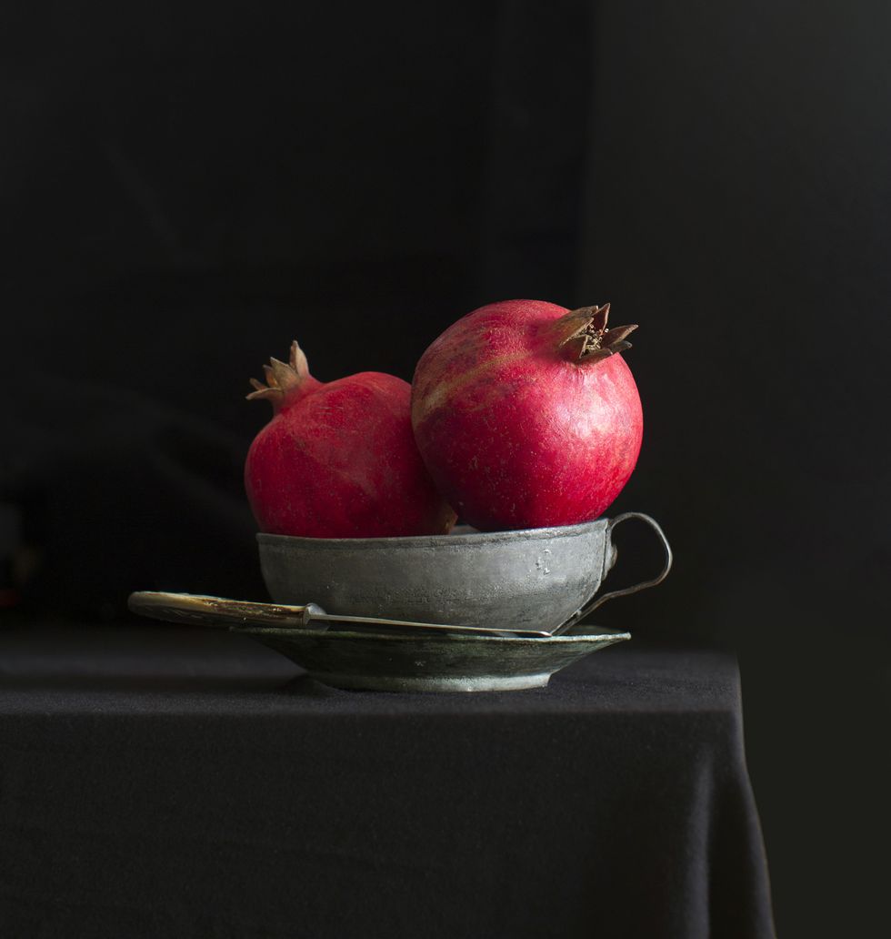 Pomegranate on black textured background.