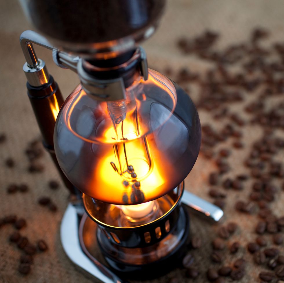 High Angle View Of Camping Stove And Coffee Beans On Table