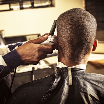 man getting buzz cut at barber shop