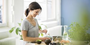 Woman preparing healthy food in her kitchen