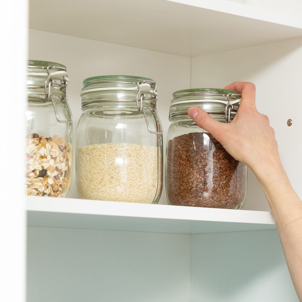 women picking an item from storage hutch smart kitchen organization concept