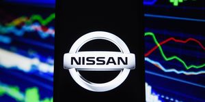 In this photo illustration a Nissan logo is seen on an