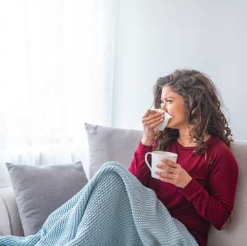 woman feeling sick on couch