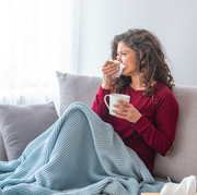 woman feeling sick on couch