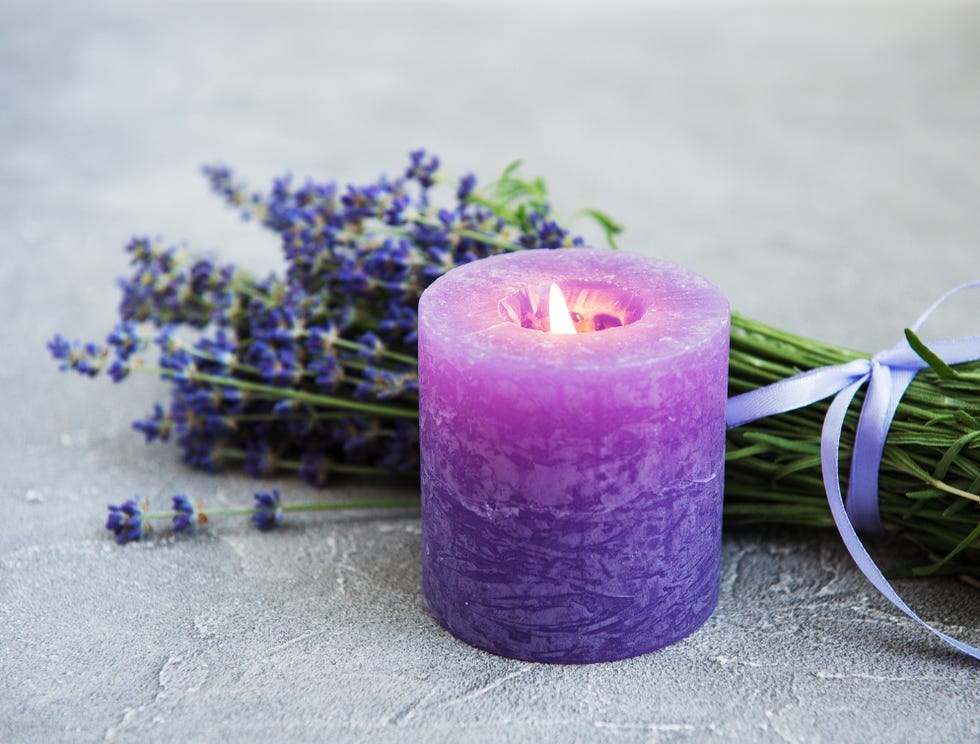 fresh lavender flowers and candle on a concrete background