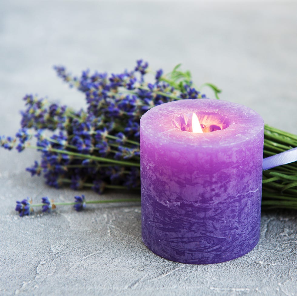fresh lavender flowers and candle fresh lavender flowers and candle on a concrete background